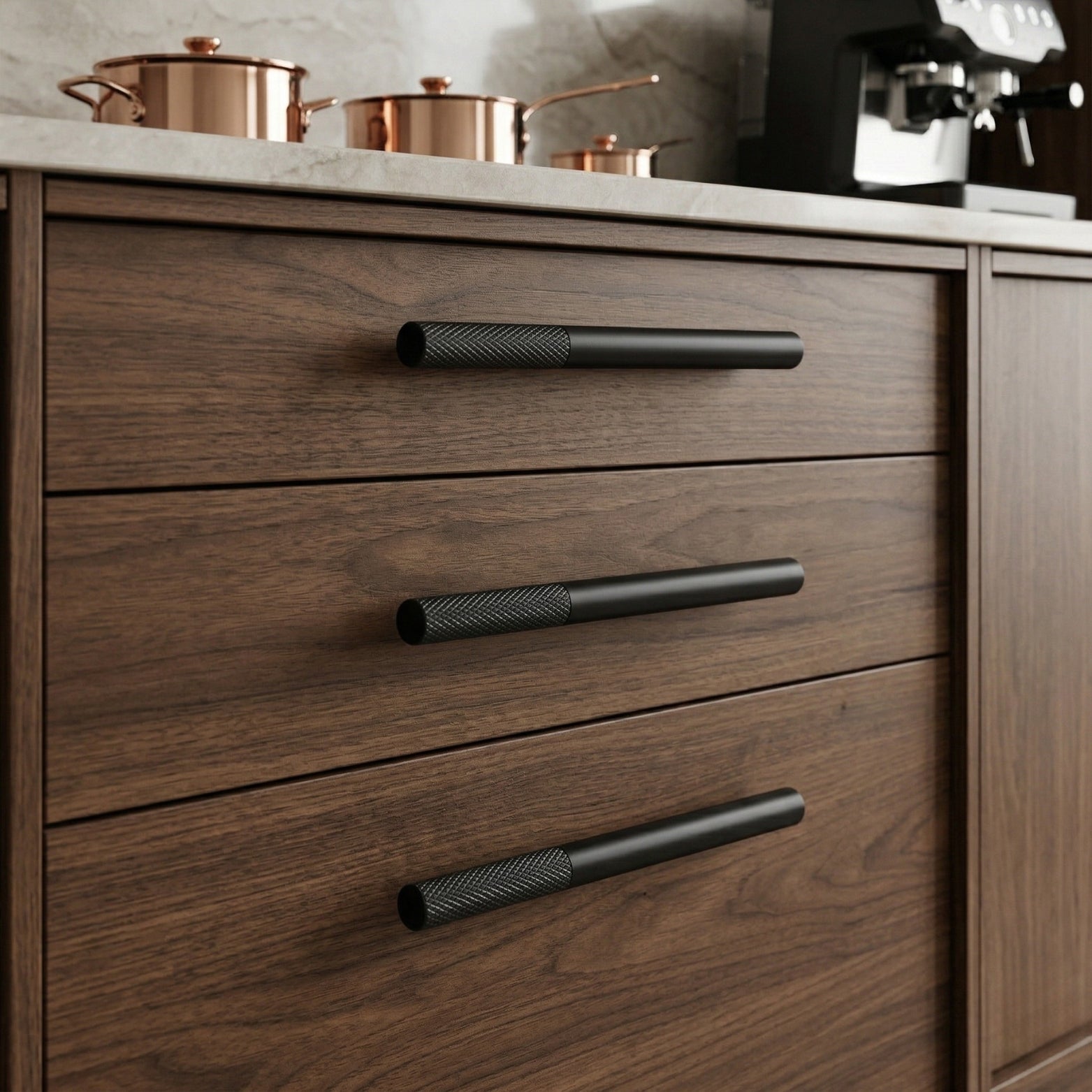 Modern matte black knurled T-bar cabinet handle made of SS304 stainless steel, shown installed on dark walnut wood kitchen drawers for a luxury industrial look.
