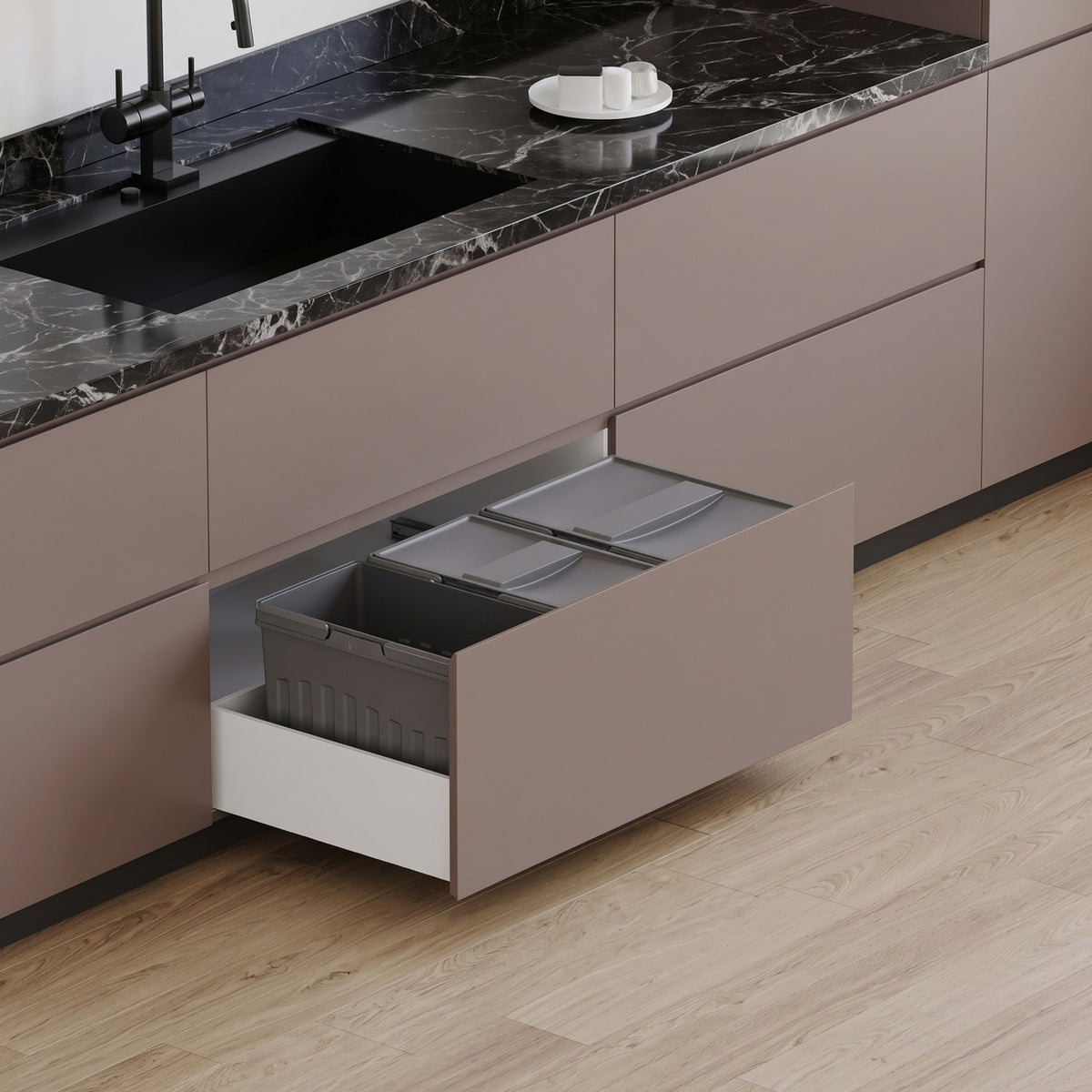 Ebco Livsmart 55L pull-out kitchen drawer bin featuring three compartments, shown installed inside a wide modern modular kitchen cabinet drawer.   