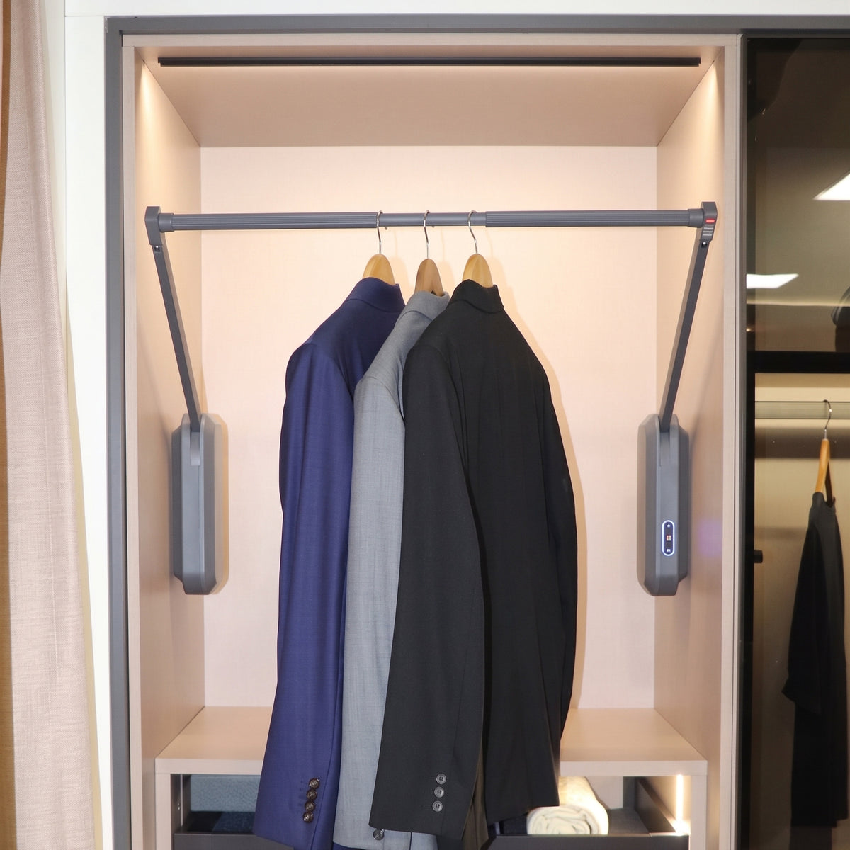 Ebco Livsmart electric wardrobe lift demonstrating its smooth lowering mechanism with garments, available online at Hardware Depot.