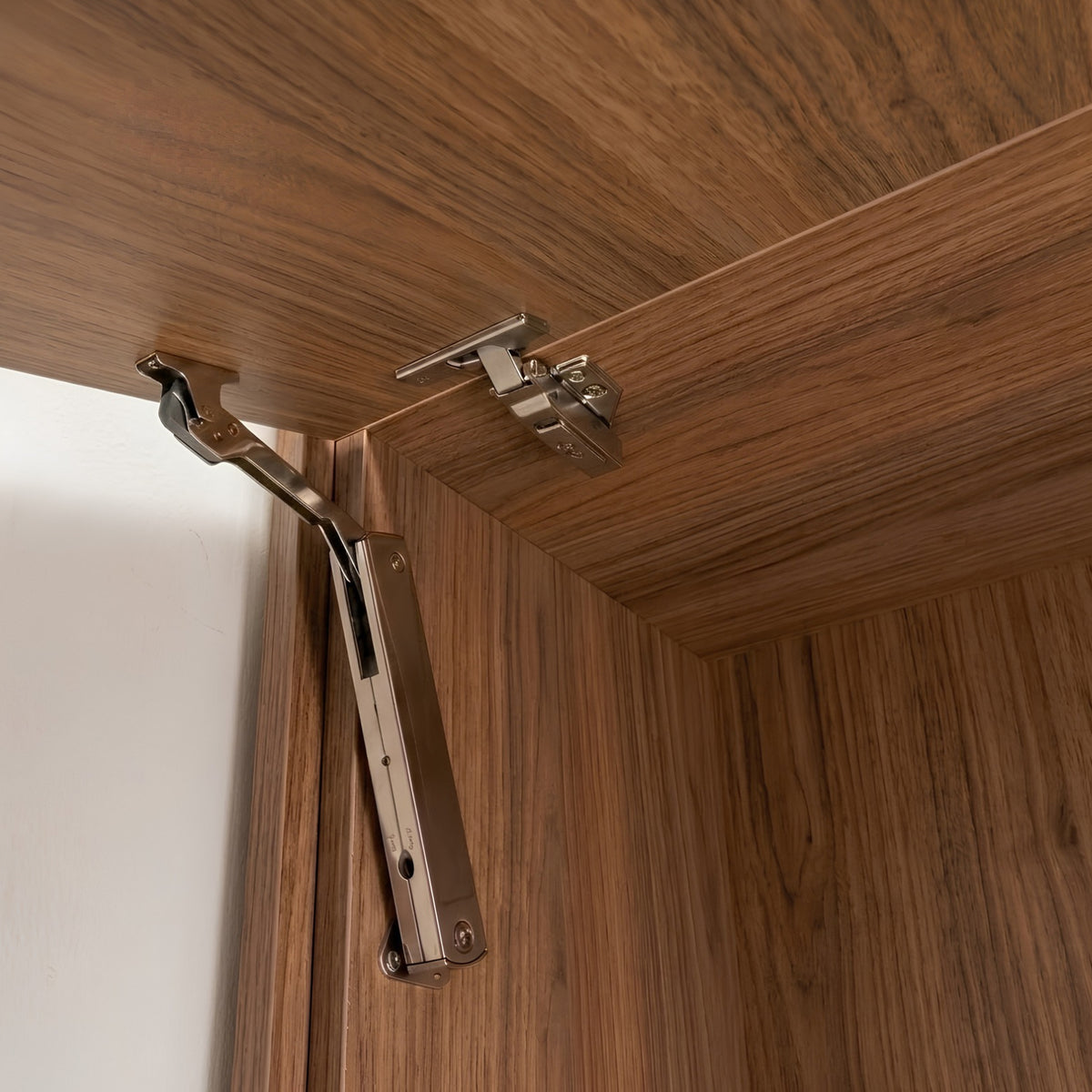 Close-up interior view of the Ebco Livsmart Heavy Shutter Lift mechanism installed on a wooden cabinet door, available at Hardware Depot.