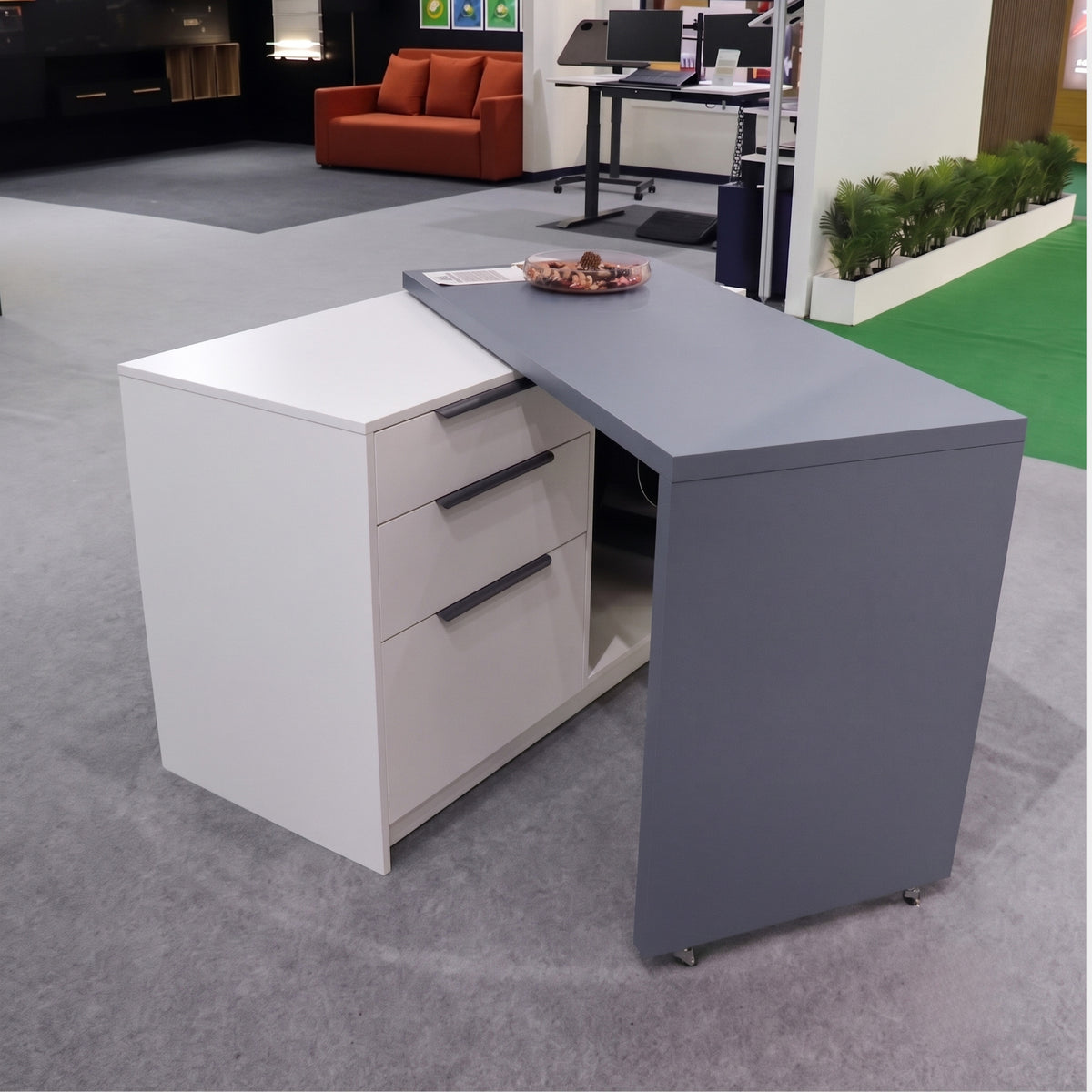 Partially extended modular desk pivoting outward, illustrating the smooth rotational movement of the Ebco table mechanism hardware from Hardware Depot