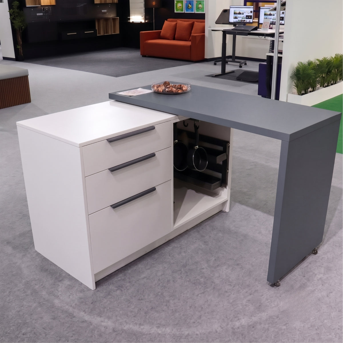Fully extended L-shaped modular desk utilizing the Ebco rotation mechanism, supported by small, low-profile caster wheels for a seamless look, available at Hardware Depot