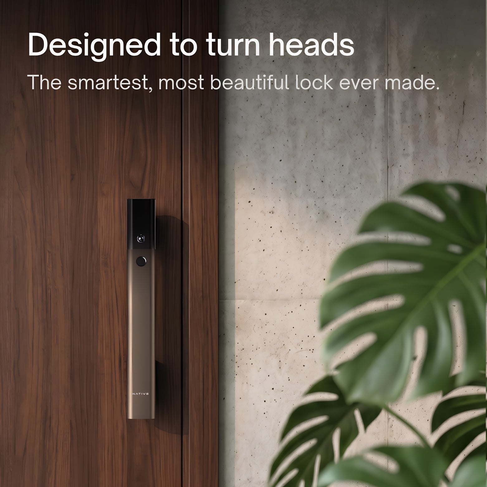 Elegant long-profile Native smart door lock in a mocha finish installed vertically on a dark wood grain door, framed by a concrete accent wall and a green Monstera plant. Text on image reads: "Designed to turn heads. The smartest, most beautiful lock ever made