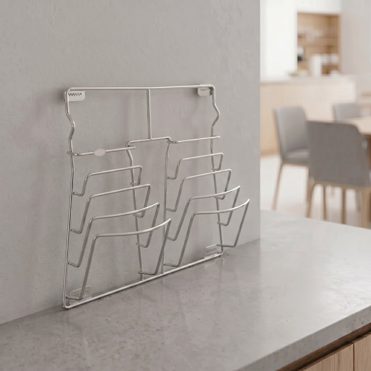 Sleek stainless steel pan lid holder and modular kitchen organizer rack mounted on a countertop wall