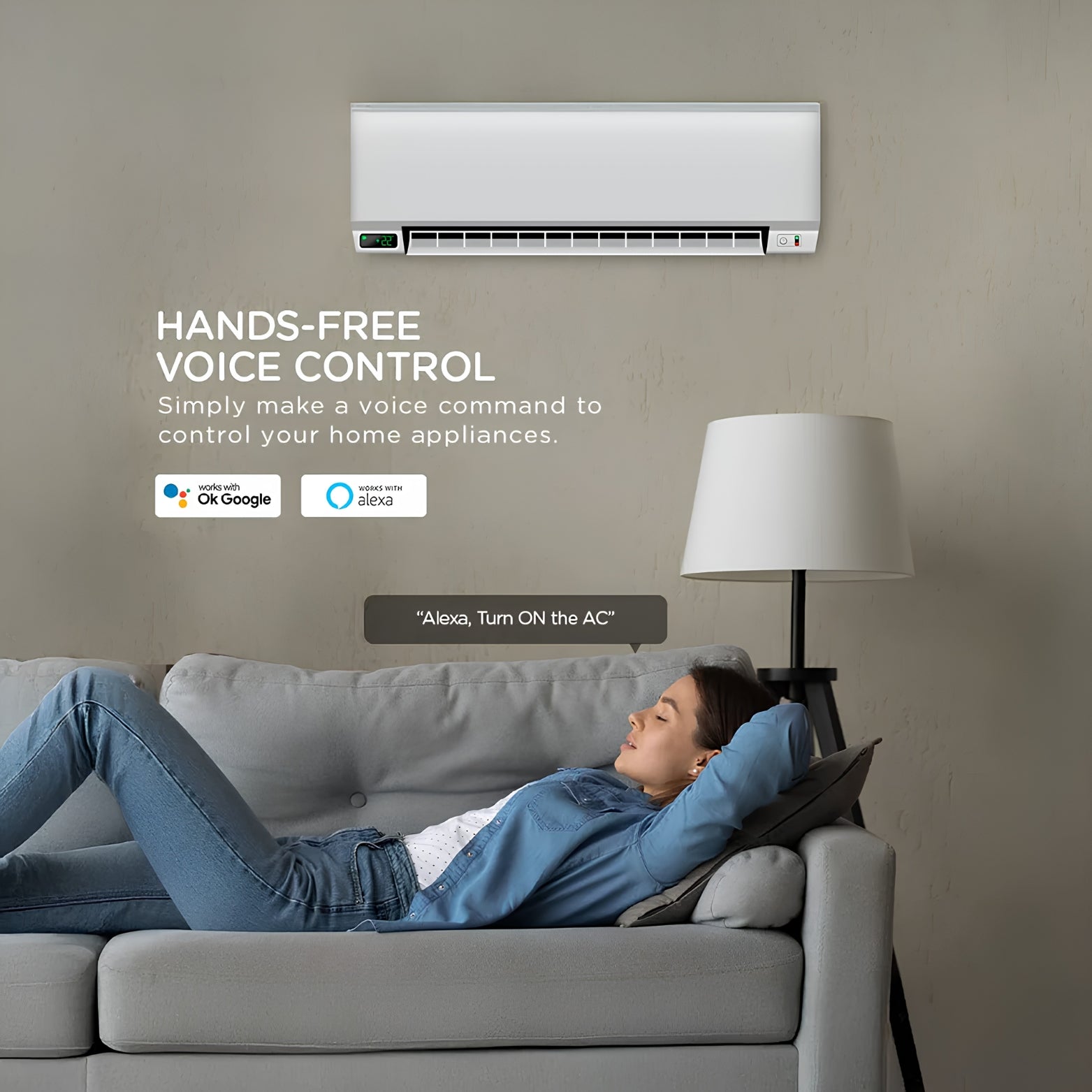 A woman relaxing on a living room sofa below a wall-mounted AC, demonstrating hands-free voice control integration with Google Assistant and Alexa.