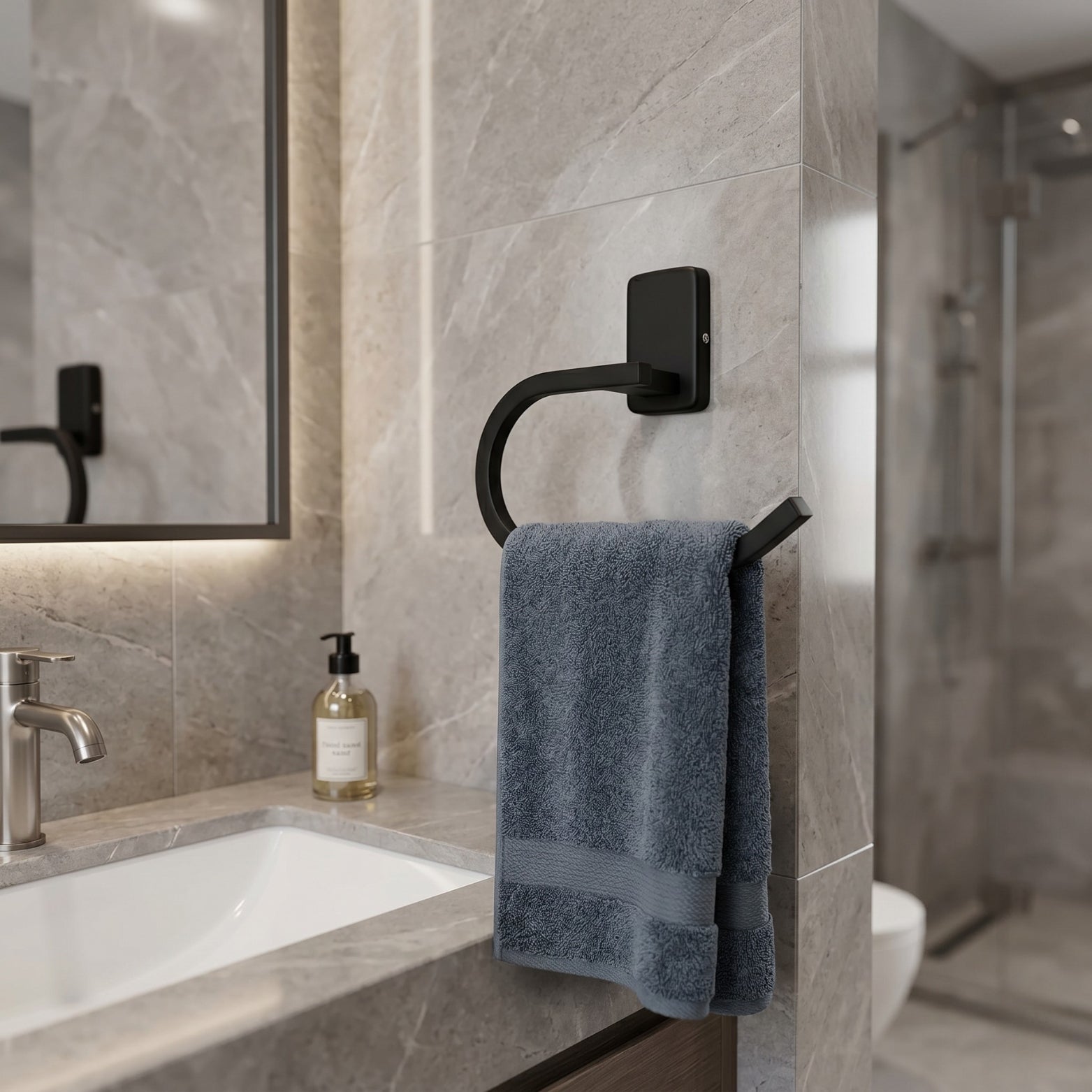 Premium Sparrow SS304 towel ring in Matt Black finish mounted on a modern grey marble wall over an elegant vanity sink counter.