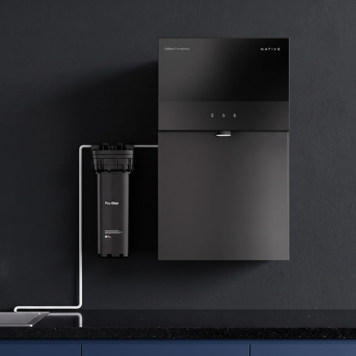 A sleek, black Urban Company Native M3 Pro water purifier mounted on a dark wall, featuring a minimalist digital display and an external cylindrical Pro-filter connected to its left side